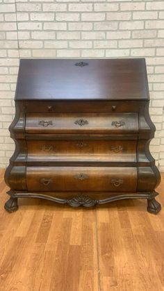 an antique wooden chest with three drawers on the bottom and one drawer at the top