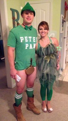 a man and woman dressed up in costume for st patrick's day, standing next to each other