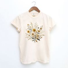 Looking for a cute versatile top to wear? Make sure to grab one of our Graphic tees! This soft and comfortable graphic tee is the perfect top for any outfit. It can be paired with biker shorts, jeans, or even a simple skirt/dress! This tee is true-to-size, so be sure to order your regular t-shirt size! If you are looking for a more oversized look, make sure to size up!