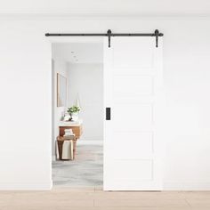 an open sliding door in a white room