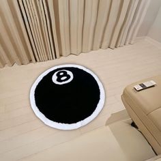 a black and white rug with the number eight on it in front of a window