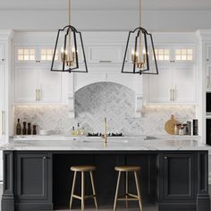 a large kitchen with white cabinets and marble counter tops, two stools in front of the island