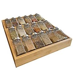 a wooden spice rack filled with lots of different kinds of spices