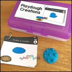 there is a cookie in a plastic container next to a playdough creation kit