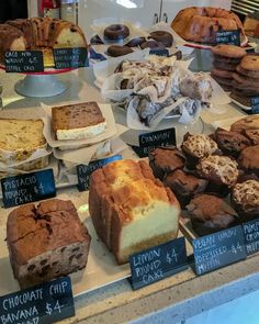 a display case filled with lots of different types of cakes and desserts on top of it