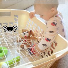 a baby playing with toys in a basket