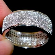 a close up of a ring with small diamonds on it's sides and in the middle