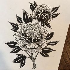 an ink drawing of two flowers on white paper