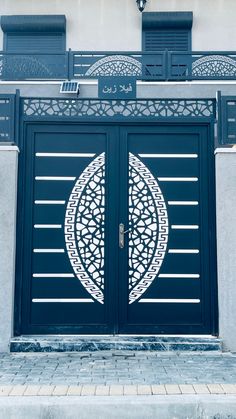 an entrance to a building with two large doors and decorative designs on the front door