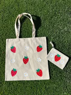 This strawberry tote bag with flowers is fun, lightweight, and is the perfect eco friendly reusable grocery tote bag. The strawberries add beautiful bright color, fun, and a cute aesthetic to go with your outfits. Use you tote bag in place of a purse, to carry your laptop, water bottle or other goodies.  This canvas tote is natural color and is 100% cotton.  Strawberry pattern may differ slightly as they are hand placed. CARE INSTRUCTIONS: Wash inside out on a gentle cycle. Hang dry. Iron inside out. Do not iron directly on top of the design.  Please message us with any questions.  Thank you! Diy Grocery Bags, Strawberry Tote Bag, Aesthetic Bag, Diy Tote