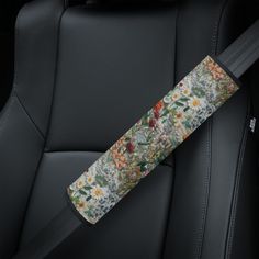 the seat belt is decorated with flowers and leaves