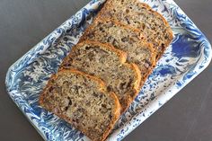 four slices of banana bread on a blue and white platter with floral design pattern