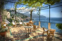 an outdoor dining area overlooking the ocean