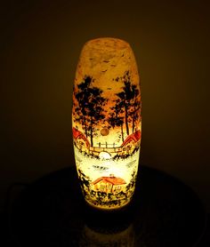 a lit up vase sitting on top of a table