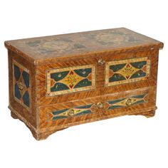 an old wooden chest with colorful designs on it