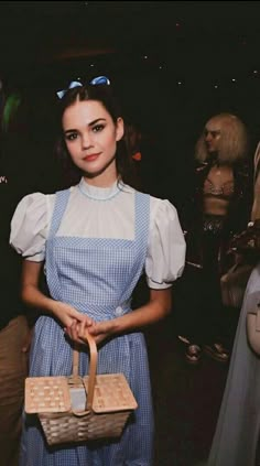 a woman in an apron holding a basket