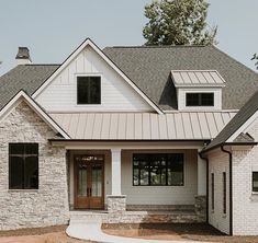 a white brick house with two story windows