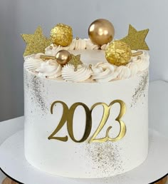 a white cake with gold decorations on top and the number twenty two in front of it