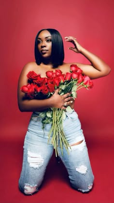 a woman holding roses in her hands and posing for the camera with one hand on her hip