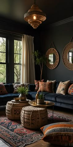 a living room filled with lots of furniture next to a large window covered in curtains