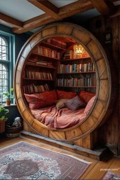 a circular bed in the middle of a room with bookshelves and windows behind it