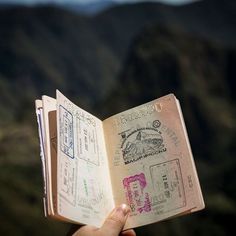 someone is holding an open book in their hand with the words, off all the books in the world, the best stories are found between the pages of a passport