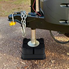 the front end of a vehicle with a chain on it's hitch plate and two yellow padlocks