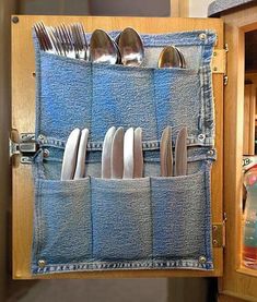 an open denim pocket holds utensils and spoons in the shape of jeans