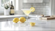 a glass filled with lemonade sitting on top of a counter