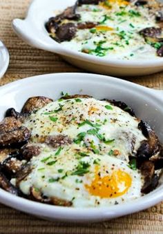 two white bowls filled with food on top of a table