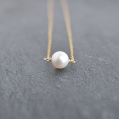 White pearls are so clean and classic. This 8mm white freshwater pearl is the perfect dainty size for casual every day look. On your choice of gold filled or sterling silver chain. This material will NOT tarnish, and can even get wet! Minimalist Pearl White Round Bead Necklace, Minimalist Pearl White Necklace With Round Beads, Classic Round Pearl Necklace For Everyday, Classic Everyday Round Pearl Necklace, Everyday Pearl Necklace With Pearl Pendant, Everyday Pearl Necklace With Round Pearl Pendant, Minimalist Akoya Pearl Round Necklace, Minimalist Akoya Pearl Necklace, Minimalist White Pearl Necklace With Round Beads