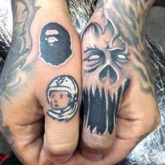 two hands with different tattoos on them