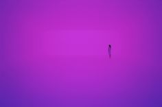 a person standing in the middle of a purple sky