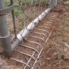 a close up of a fence that has been knocked over with metal bars attached to it