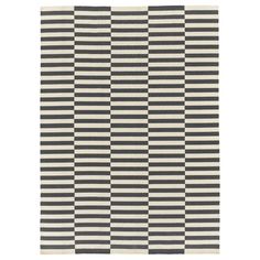 a black and white rug with vertical stripes on it's side, in the shape of a checkerboard pattern