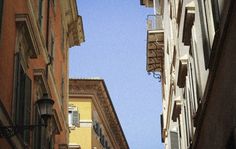 looking up at the sky from between two buildings