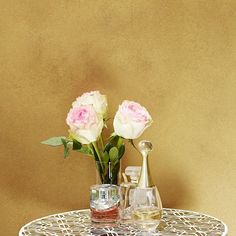 two vases with flowers sitting on a table