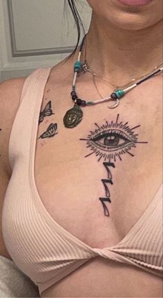 a woman with an all seeing tattoo on her chest