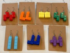 3D printed earrings inspired by Tetris. Originally designed as a gift for my wife to honor her favorite game, these are assembled by our daughter. Earrings are 3D printed using PLA - a plastic made from renewable resources like corn. Hooks are stainless steel and include a silicone earring back. Tetris Earrings, 3d Printer Earrings, 3d Printing Jewelry, 3d Print Jewelry, 3d Print Earrings, 3d Printer Jewelry, 3d Earrings, 3d Printed Earrings, 3d Printed Jewelry