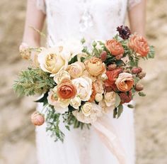 a bride holding a bouquet of flowers in her hand