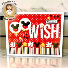 a card with mickey mouse on it and the words make a wish written in white