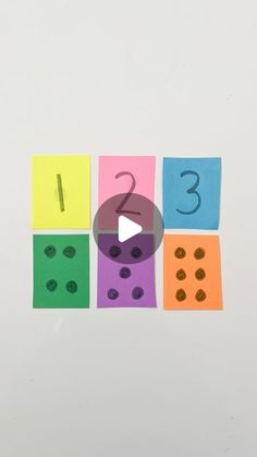 a video game with numbers and dices cut out from colored paper on a white background