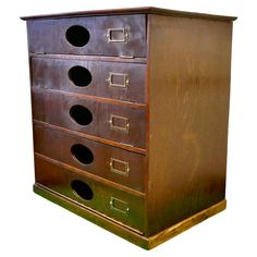 an old wooden dresser with five drawers and four knobs on the front, side view