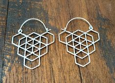 the earrings are made out of metal wire and have geometric designs on each earring