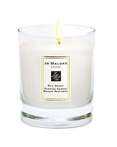 a candle that is sitting in front of a white background with the words jo malone on it