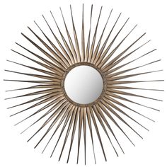 a mirror that is sitting on top of a white wall and it's sunburst