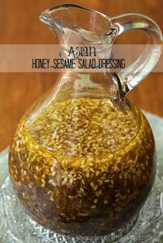 a glass pitcher filled with honey sesame salad dressing