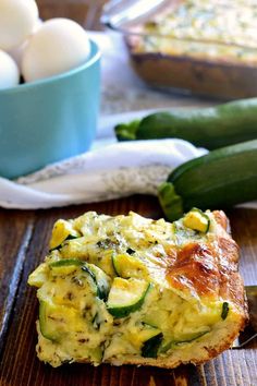 an egg and zucchini quiche on a wooden table