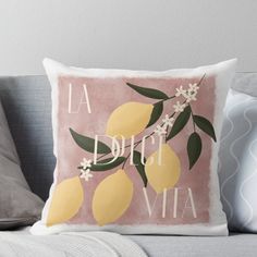 a pink pillow with lemons and the words la dolce vita on it in white lettering