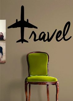 a chair sitting in front of a wall with the word travel written on it next to an airplane